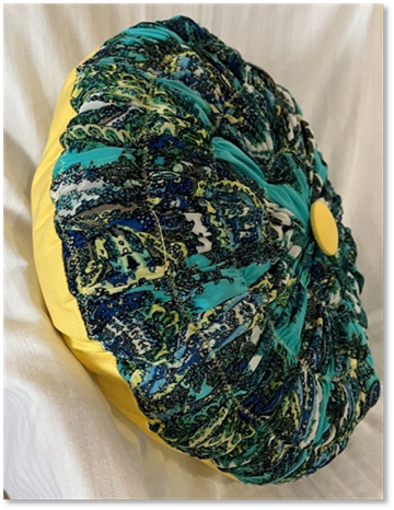 A pillow on a white surface
Description automatically generated