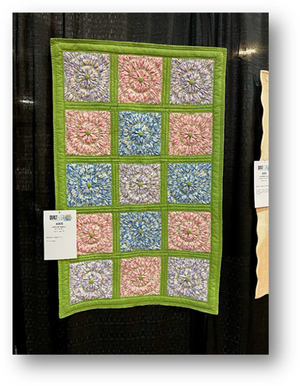 A colorful quilt on a black background
Description automatically generated